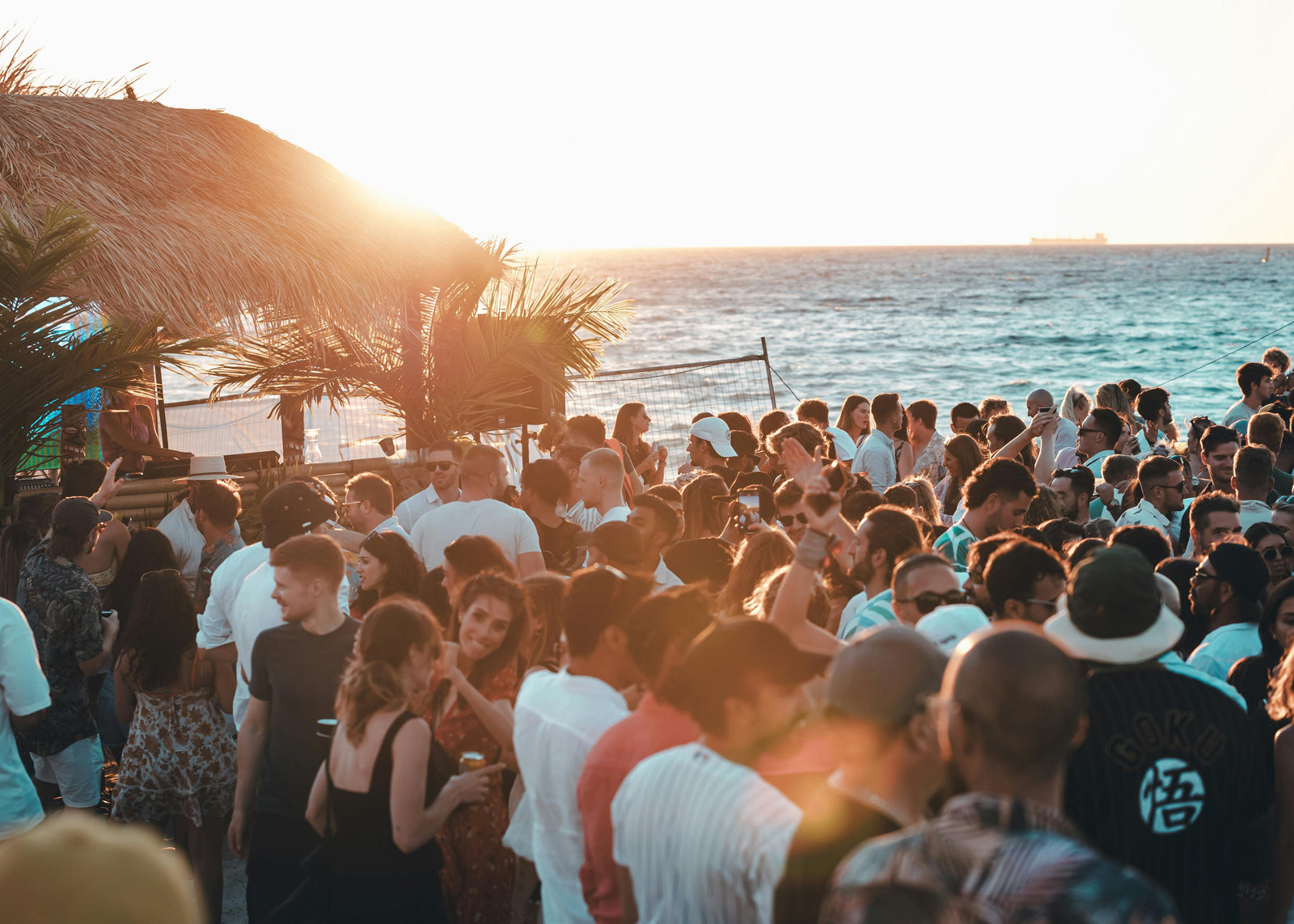 A outdoor wedding on a florida keys beach at sunset with bartenders and guests