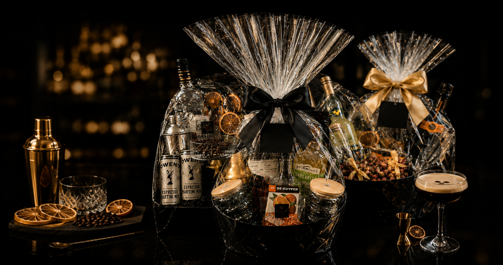 Gourmet cocktail gift basket with alcohol bottles and dried garnishes on a dark background