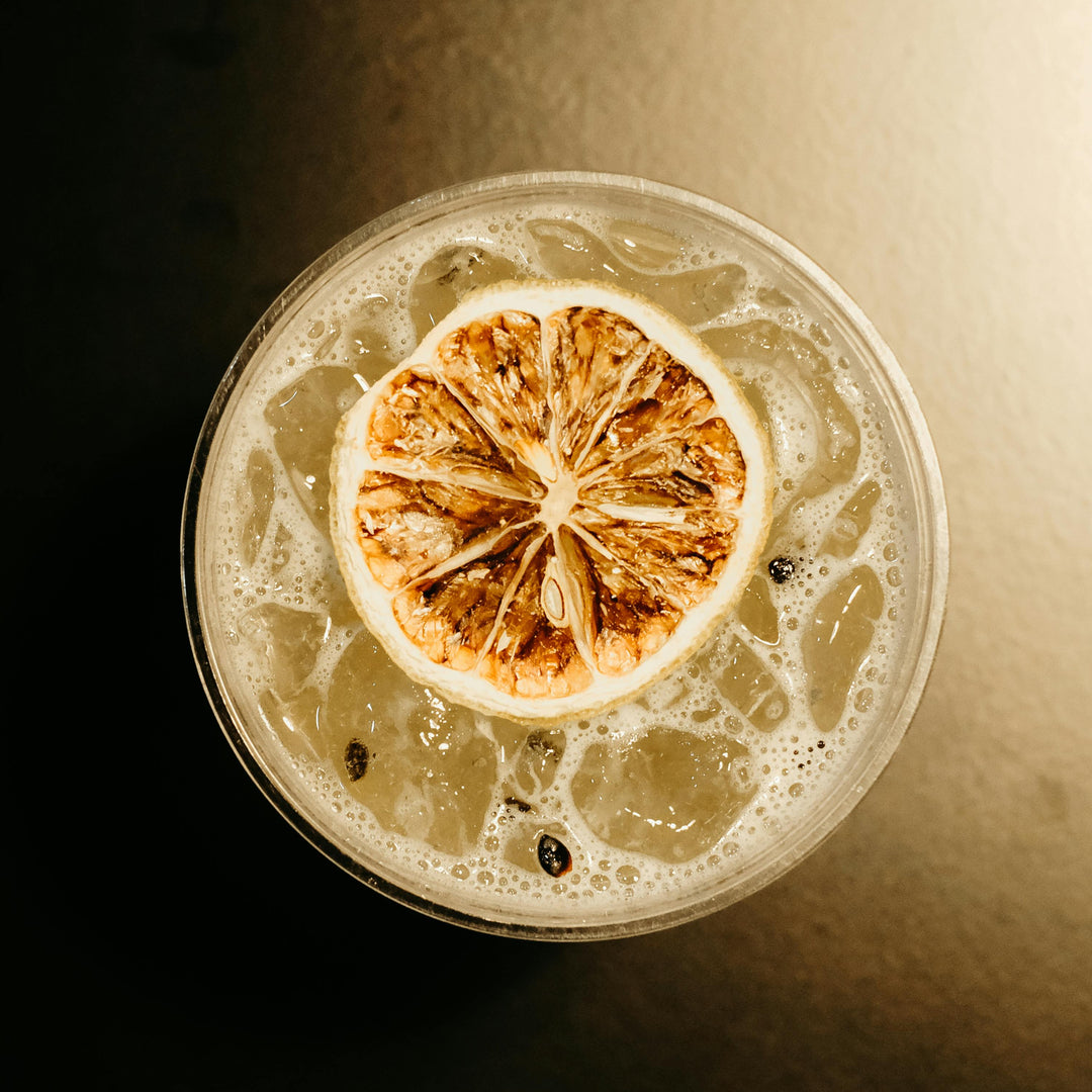 Cocktail with a lemon wheel on a dark background