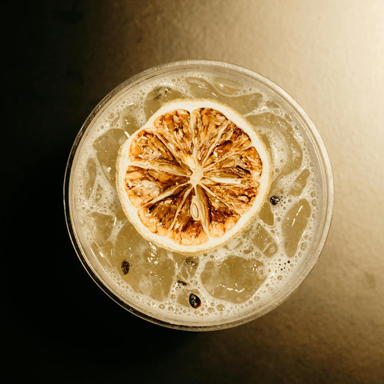 Cocktail with a lemon wheel on a dark background