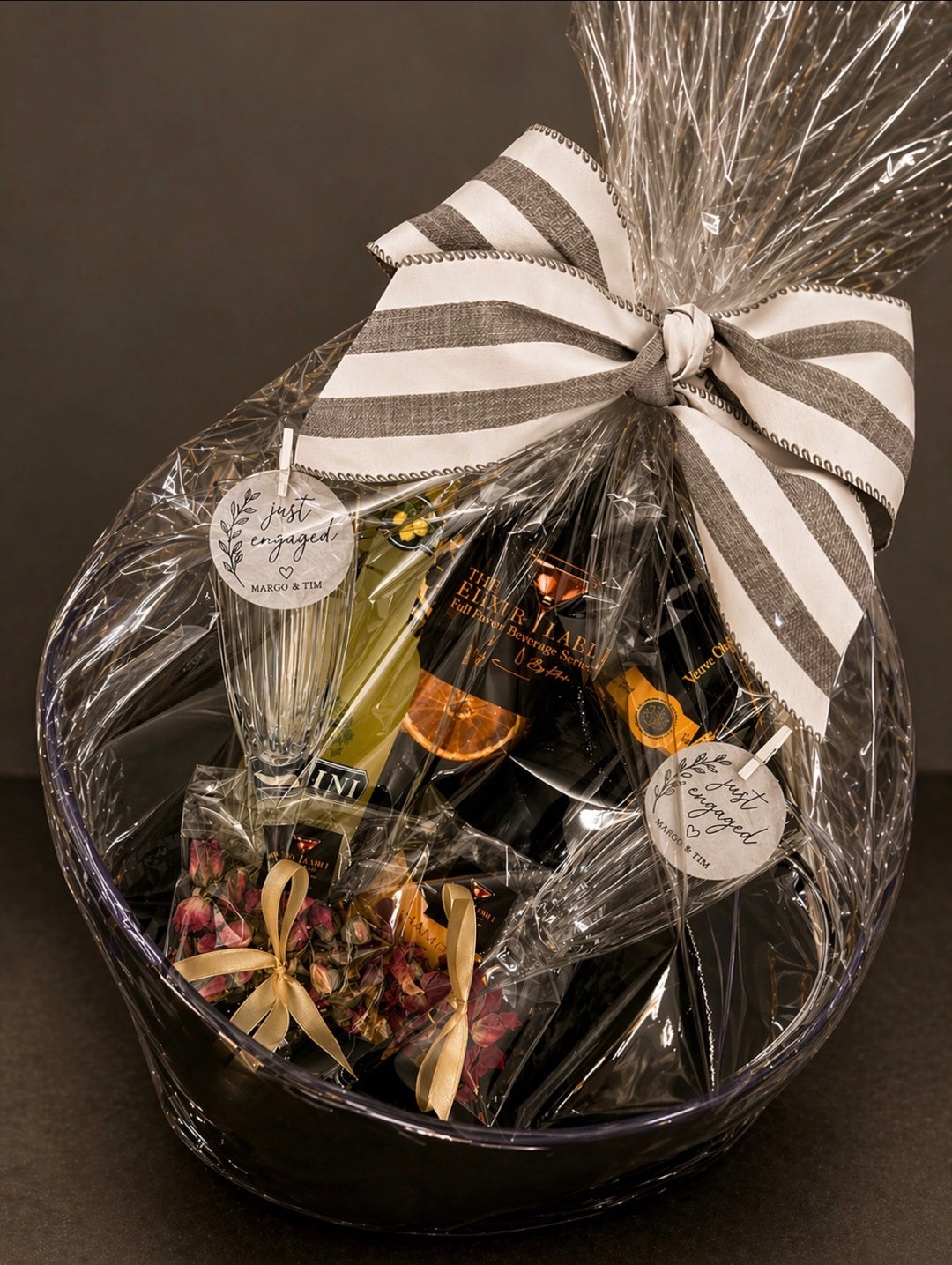Cocktail Gift basket with garnishes, a champagne, and a glass on a dark background