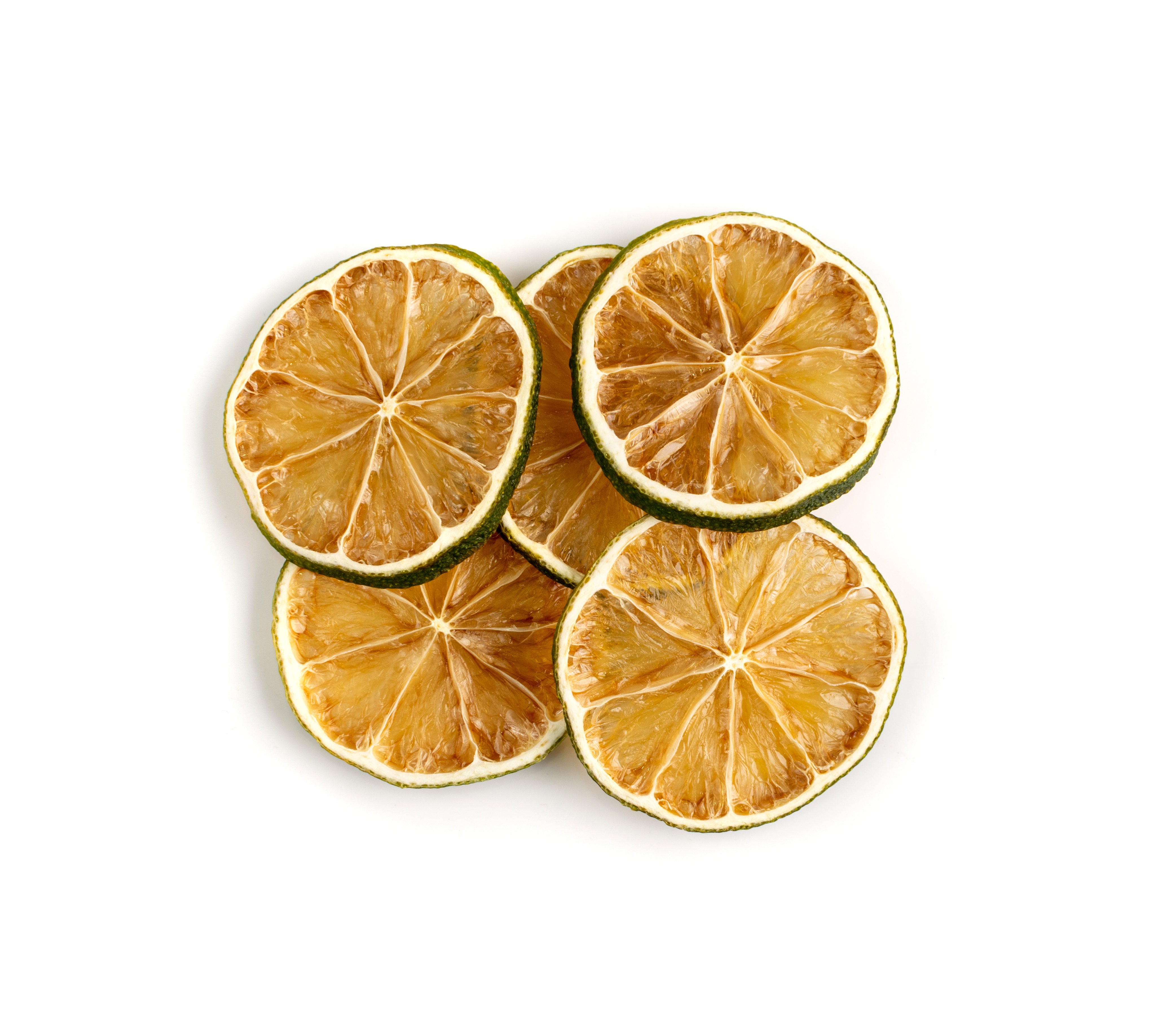 Dried lime wheels on a white background