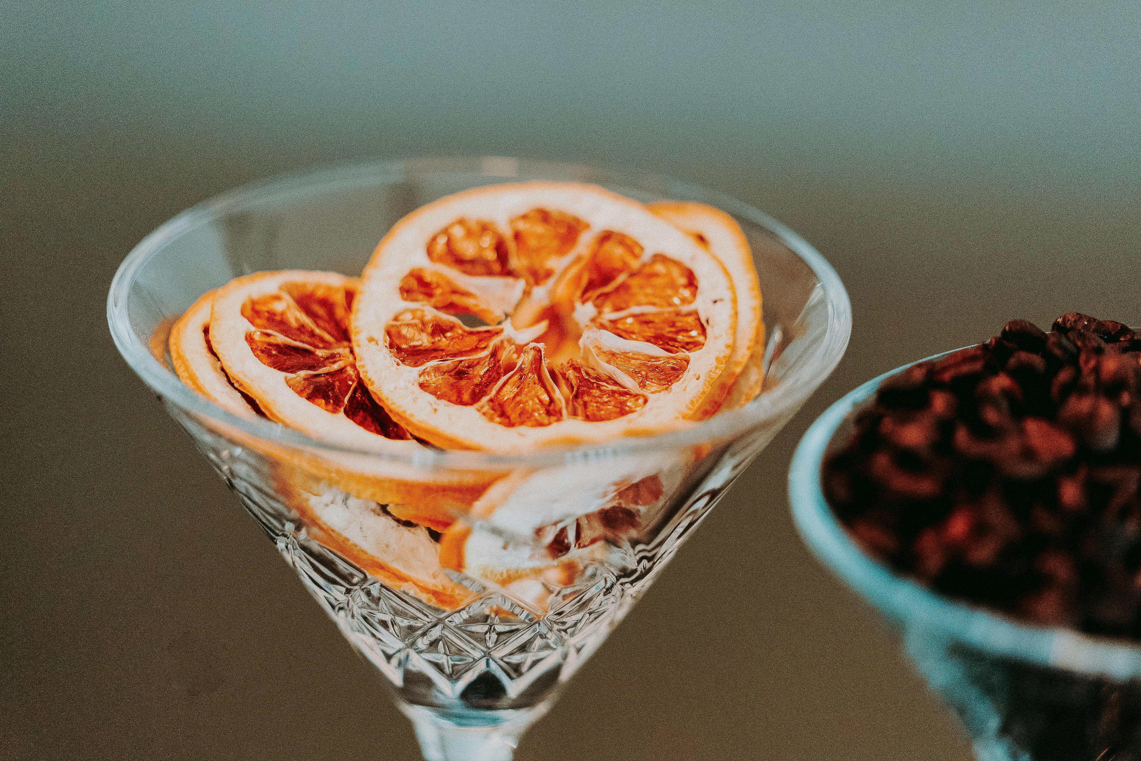 Dried orange slices in a martini glass with a blurred background